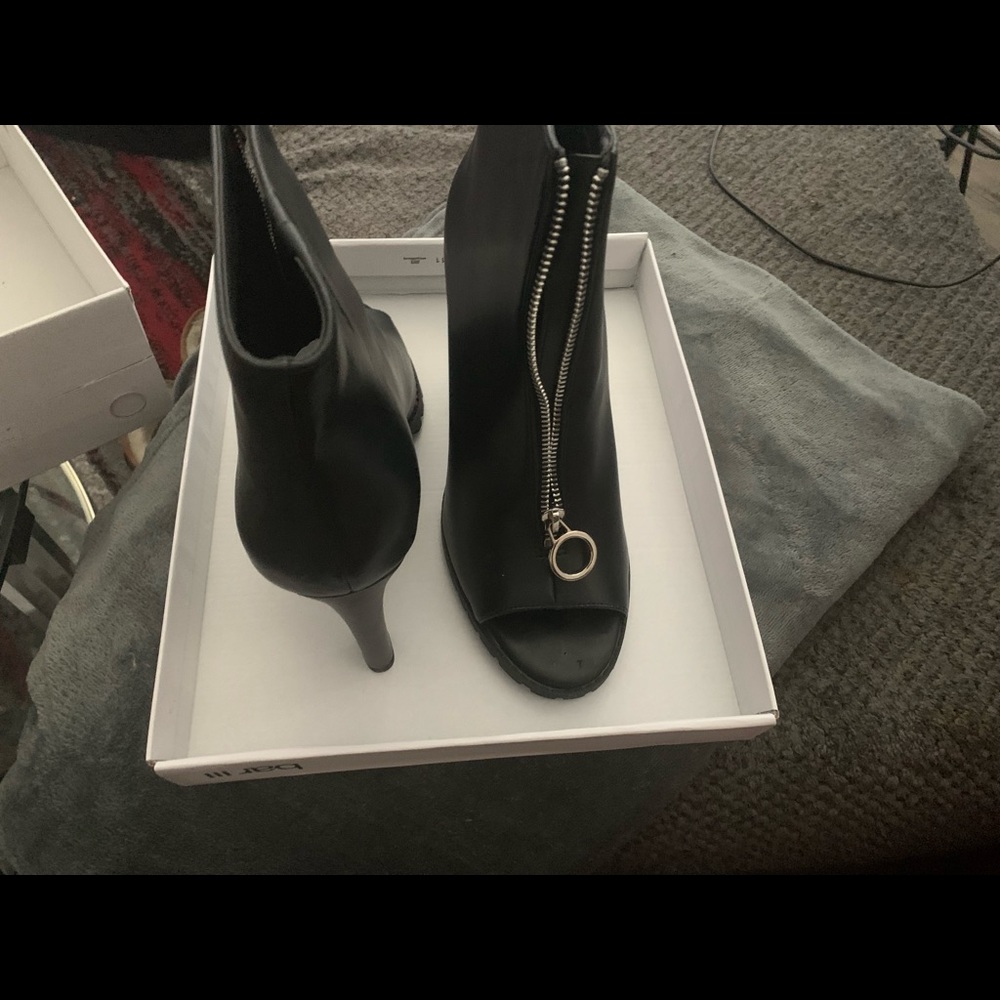Black booties purchased from Macys never worn brand new in box no scratches.